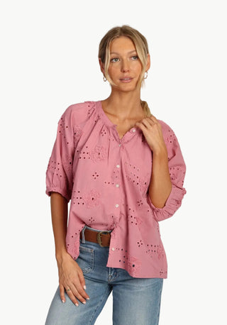 Dylans womens house featuring Woman wearing a pink blouse with eyelet details and blue jeans