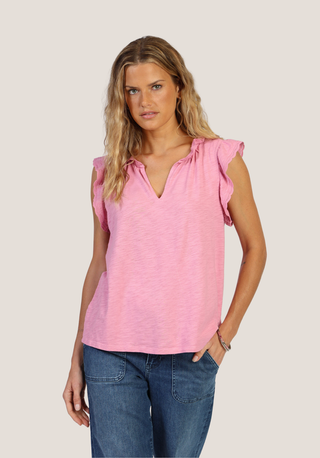 Woman wearing a pink top with ruffled sleeves featuring Dylan women's Clothing