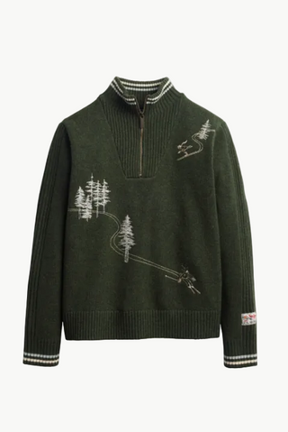 An olive green ribbed knit quarter-zip sweater with white embroidered forest and ski motif details, shown against a plain white background.
