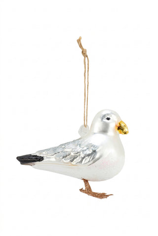 Glass seagull ornament hanging on a white background