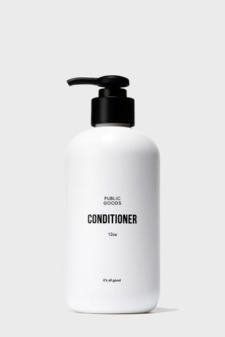 A white bottle with a black pump labeled 'Public Goods Conditioner', with a capacity of 32 oz.
