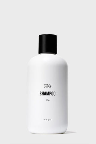 A white bottle labeled 'SHAMPOO' with a black cap, on a white background.
